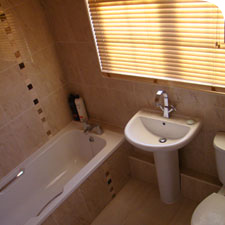 photograph of a bath, sink and toilet