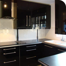 photograph of modern fashionable, black high gloss kitchen