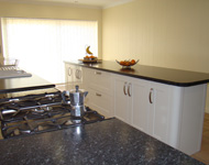 Large spacious kitchen, with a luxurious worktop and appliances.