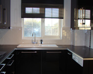 Fashionable kitchen with a piano gloss black finish.